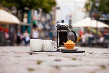 french press coffee with two mugs and muffin
