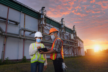 female inspectors and architects discuss with head engineer about construction project.Multi-ethnic group of engineers meeting at construction site in eveing time