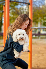 girl doing exercises with a dog in her hands