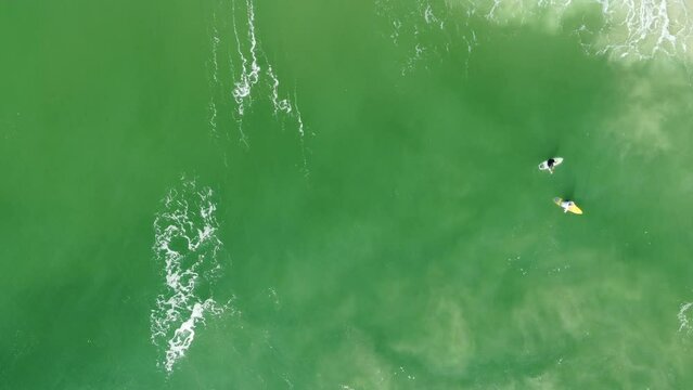 surfers waiting for good surf on the lineup at surfers paradise goldcoast