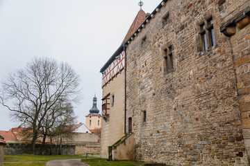 Fototapeta na wymiar Fortified medieval stronghold, Moated gothic castle at romantic style, National cultural landmark in winter day, Budyne nad Ohri, Northwest Bohemia, Czech Republic