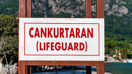 Lifeguard signboard in Turkish language reading Cankurtaran and English translation in...