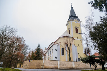 Fototapeta na wymiar Baroque Church of All Saints in winter day, Chapel near castle, Libochovice, Litomerice district, Bohemia, Czech Republic