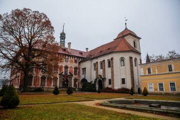 Fototapeta na wymiar Castle Libochovice with French style park and garden, Romantic baroque chateau in winter day, Castle Chapel of Sacred Heart of Jesus, Litomerice district, Bohemia, Czech Republic