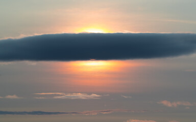 Fototapeta na wymiar Beautiful sunset: sunlight of sun behind dark cloud, 