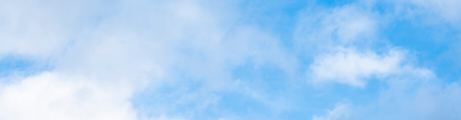 Stunning view of a blue sky with white fluffy clouds during a sunny day. Natural background with copy space.
