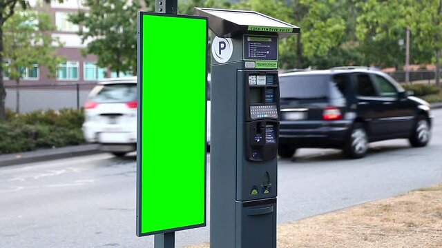 Green billboard for your ad beside parking meter on the street