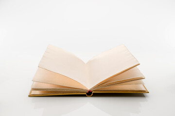 Open antique style book with pages of rough paper with jagged edges, antique leather hardcover notebook isolated on white background