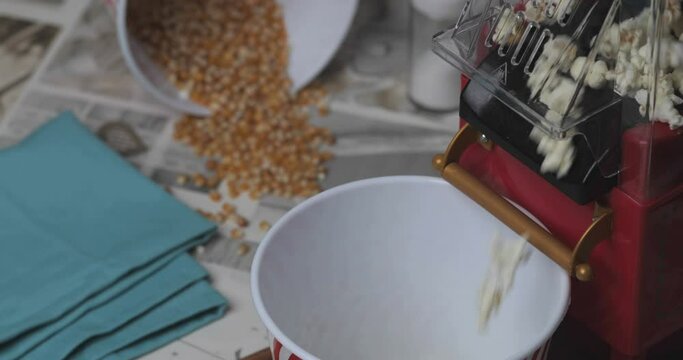popcorn machine and bucket on a wooden table, making popcorn at home