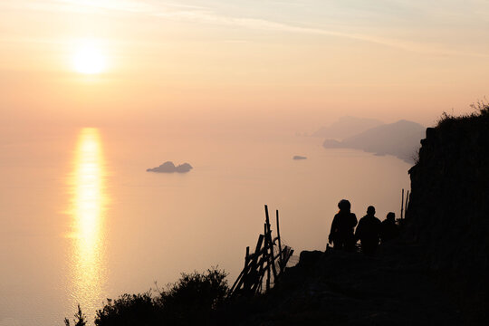 Silhouette Of People walking along the path of the gods in a spectacular sunset over the sea. Amalfi coast,  island of Capri, Campania, souther Italy.