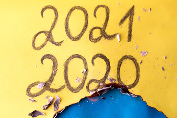 Happy new year, new beginning. Text of the year 2020, 2021. Yellow background.