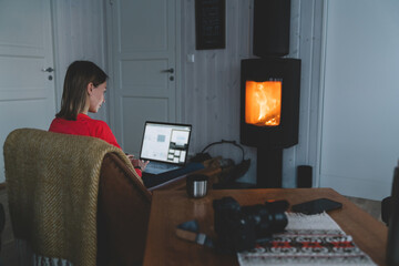 Woman using laptop in cozy room