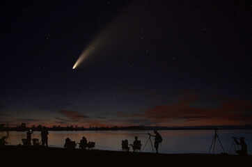 Naklejka na ściany i meble Comet Neowise comet C/2020 F3 (NEOWISE) and crowd of people silhouetted by the Ottawa river watching and photographing the comet