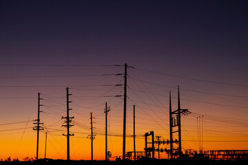 Silhouette of Power Station with Transmission Towers at Sunset