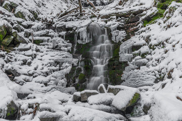 Waterfall on Bucaci creek in Moravskoslezske Beskydy mountains in cold snowy day