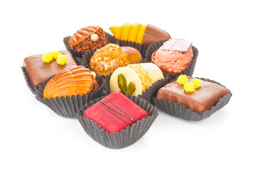 Few chocolate praline candies close up on white background