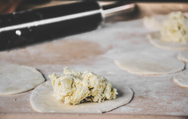 Making dumplings with filling inside.