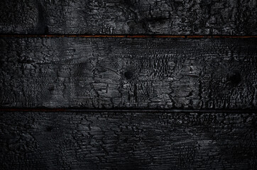 burnt wooden background. the horizontal black boards
