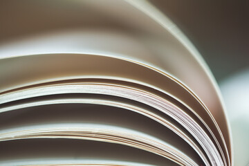Black and White image of an open book with pages curved.