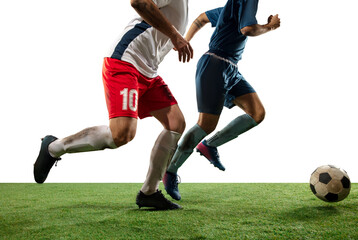 Tensioned. Close up legs of professional soccer, football players fighting for ball on field isolated on white background. Concept of action, motion, high tensioned emotion during game. Cropped image.