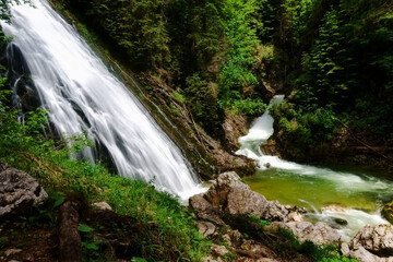 Obraz premium wonderful waterfall with white water in a green nature