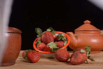 Fresh strawberry fruit pile with blur background.