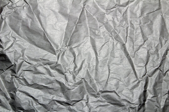 Crumpled plain grey paper for background or wallpaper or webpage illustration  