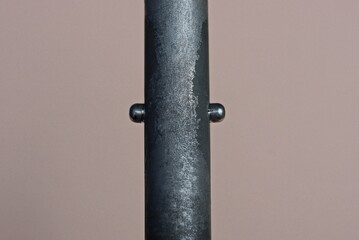 part of metal shabby gray black tube on brown background
