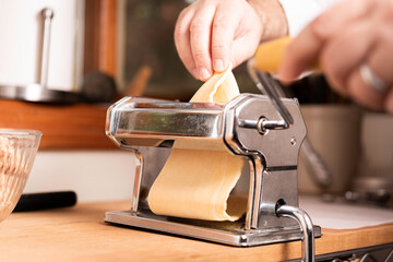 Making Pasta and Tortellini at Home on Wooden Rack and Chrome Pasta Maker