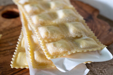 Handmade uncooked fresh ravioli with four cheeses filling, tasty vegetarian food