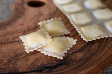 Handmade uncooked fresh ravioli with four cheeses filling, tasty vegetarian food