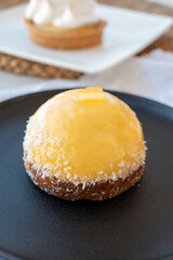 Small yellow  lemon ball tart from French pastry shop