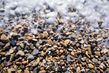 The image of stones and pebbles exposed to waves for years