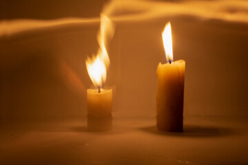 Photo of a burning candle with a yellow flame	