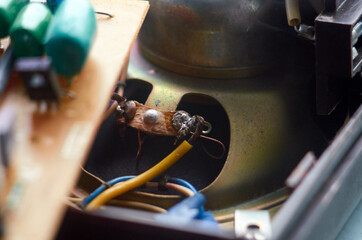 Fototapeta na wymiar Poorly soldered wire to the tape recorder speaker
