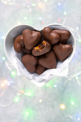 Traditional handmade gingerbread heart cookies with filling chocolate glazed on bright lighted background