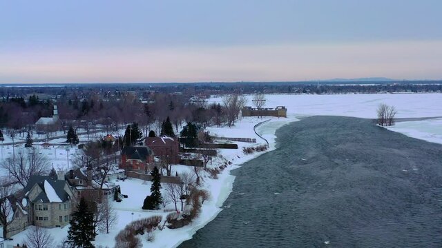 river to frozen lake, also a militar building from 1600 in winter time
