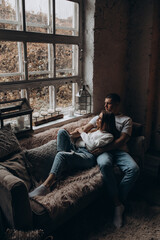 The guy hugs his girlfriend. A loving couple in a cozy home environment. Studio photography.