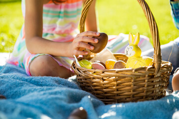 Cute boy and girl celebrating Easter, searching and eating chocolate eggs. Happy family holiday....