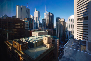 view of the buildings and skyscrapers of the Sydney business district lit by the Sun, Sydney city Australia.