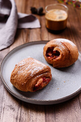 Puff pastry rolls with fruit and coffee on wooden table. Danish pastries. Christmas breakfast