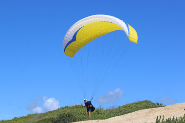 Paraglider launching above Victory Walls beach, Portugal	