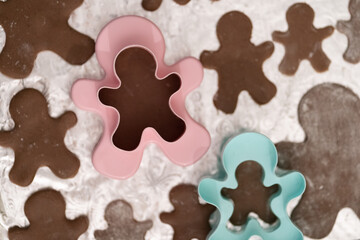Boy teenager prepares for Christmas and bakes gingerbread men. Good New Year spirit. Delicious cookies.