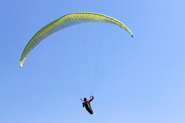 Paraglider flying wing in a blue sky	