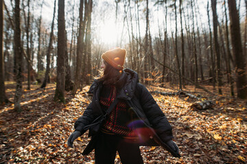 happy young woman in autumn winter forest