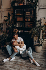 Fototapeta na wymiar The guy hugs his girlfriend. A loving couple in a cozy home environment. Studio photography.