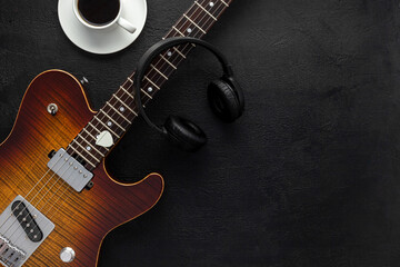 Desk of musician for songwriter work set with headphones and guitar