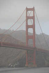 view of one tower of golden gate bridge on a cloudy day