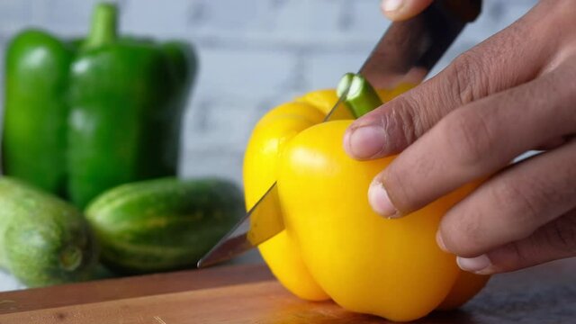 cutting Yellow capsicum on chopping background 