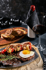 Grilled meat platter. Assorted delicious grilled meat with vegetables. Grilled mixed meat with pepper sauce and vegetables. Chef's hands spread meat on a plate